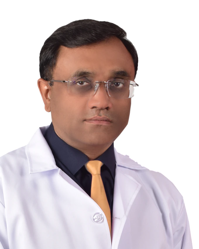 Portrait of Dr. Anil Srivastava in a white coat, navy shirt and gold tie